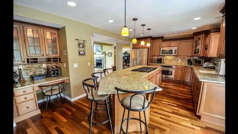 Full kitchen remodeling transformation featuring hardwood floors and recessed lighting
